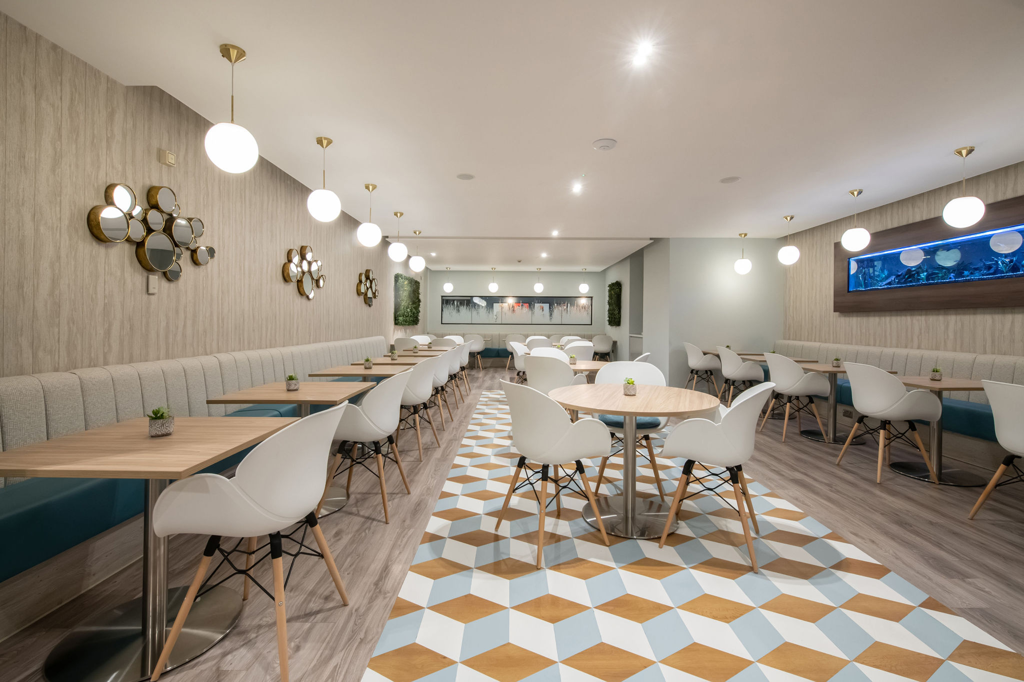 modern cafe dining area with white chairs and wooden tables