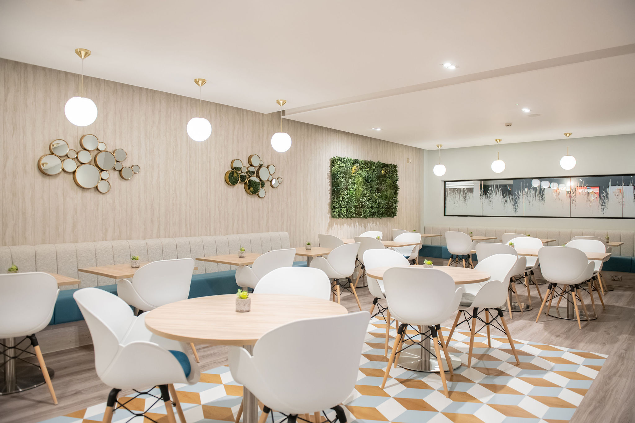 modern bright cafe seating with white chairs and wooden tables