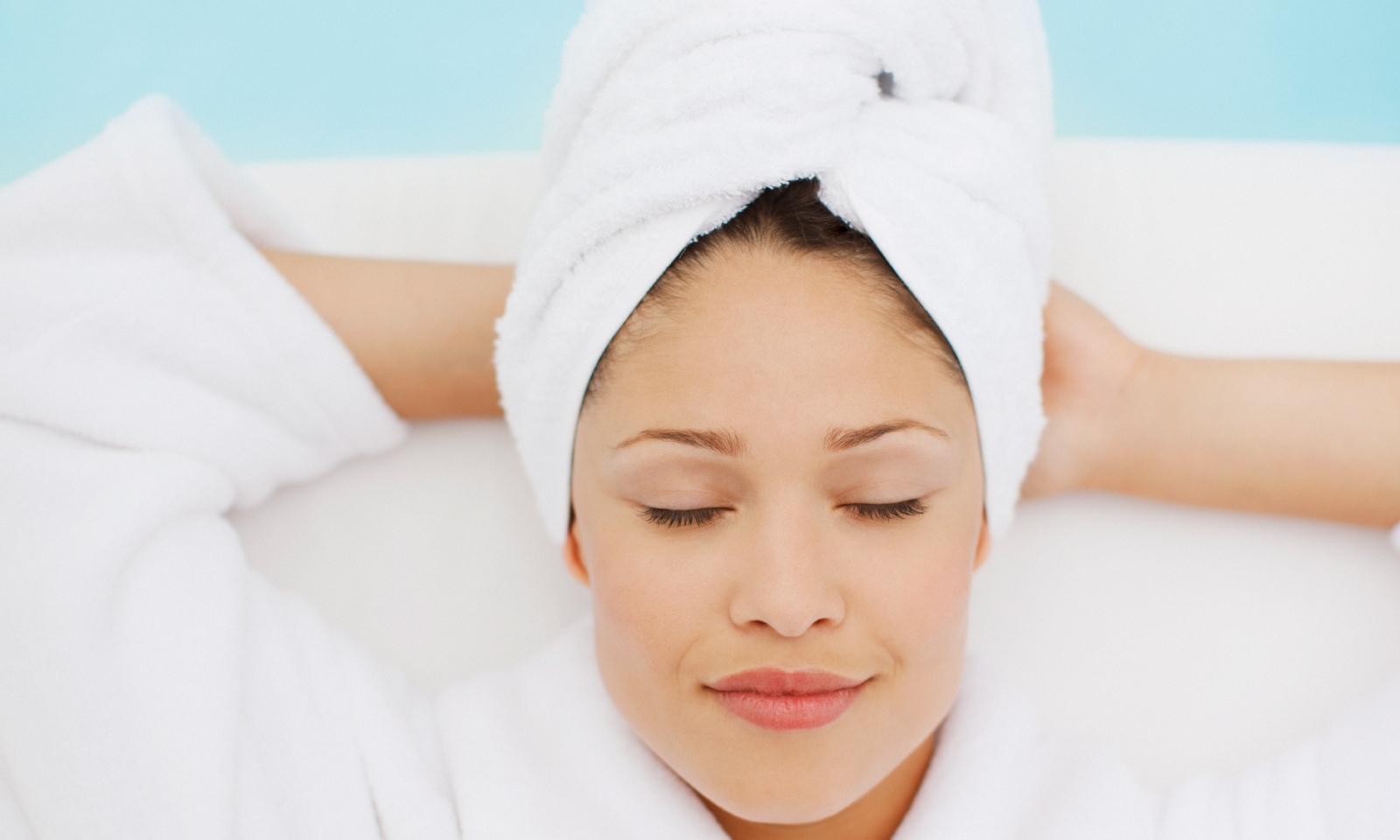 woman relaxing with towel on head in bathrobe