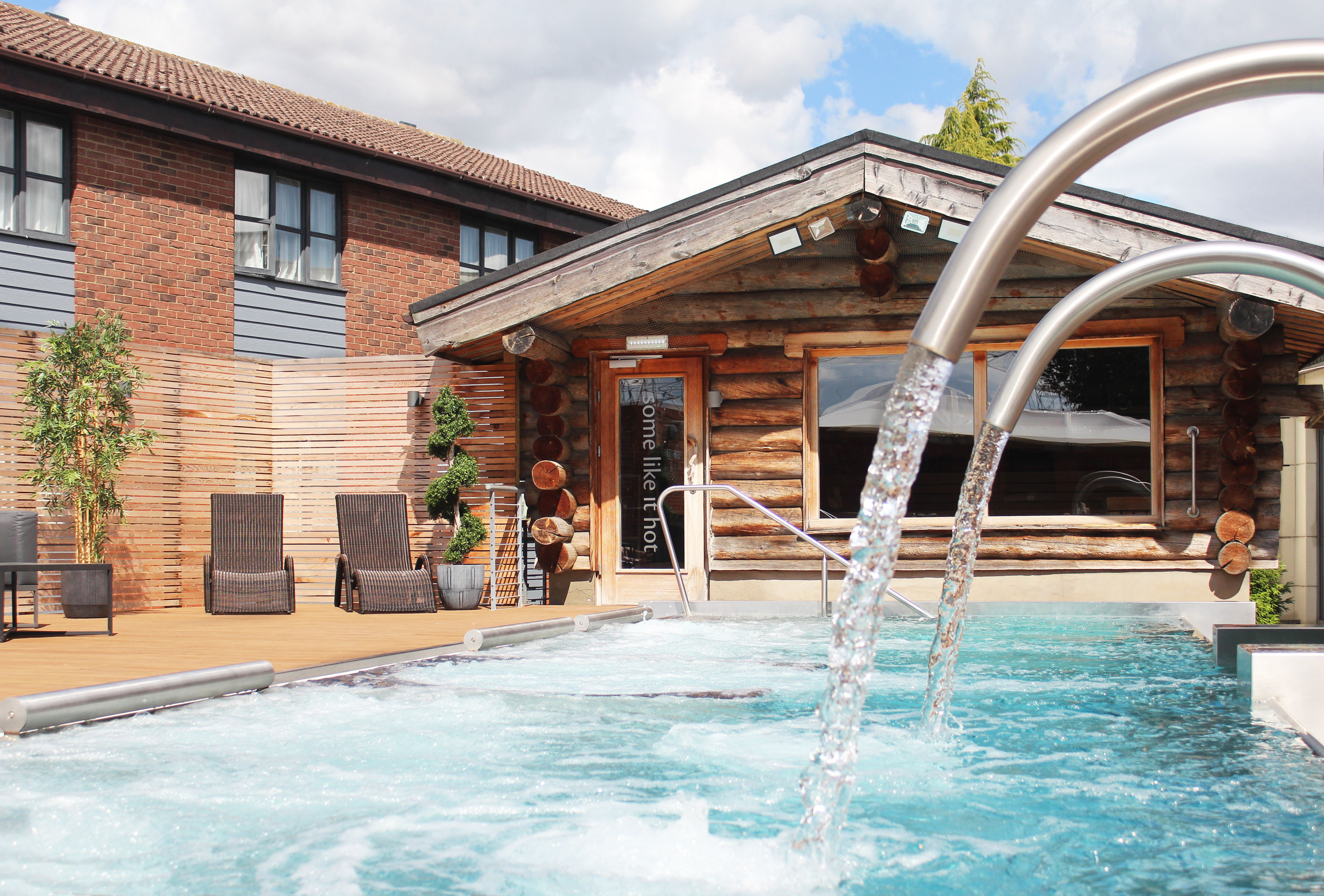 outdoor spa pool with wooden cabin background